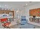Open concept living space features a modern kitchen and comfortable seating areas with bright, natural light at 9630 W Atlantis Way, Tolleson, AZ 85353