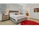 Comfortable main bedroom featuring a tufted headboard, side tables, and view to ensuite bath at 9630 W Atlantis Way, Tolleson, AZ 85353