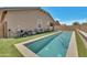 Backyard featuring a sleek pool, lush artificial grass, and a relaxing lounge area at 9630 W Atlantis Way, Tolleson, AZ 85353
