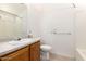Well-lit bathroom featuring a functional vanity, toilet, and shower with tub at 975 E Lincolnwood Cir, Casa Grande, AZ 85194