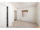 Cozy bedroom featuring neutral carpet and white sliding door closet at 975 E Lincolnwood Cir, Casa Grande, AZ 85194