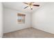 Neutral bedroom offering neutral carpeting, a window, and ceiling fan at 975 E Lincolnwood Cir, Casa Grande, AZ 85194