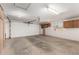 Spacious two-car garage with built-in cabinets and concrete flooring at 975 E Lincolnwood Cir, Casa Grande, AZ 85194