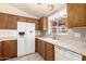 Close-up of the kitchen, featuring a white refrigerator and ample counter space at 975 E Lincolnwood Cir, Casa Grande, AZ 85194