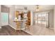 View of the kitchen with bar seating and a sliding door to the backyard pool at 975 E Lincolnwood Cir, Casa Grande, AZ 85194