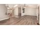 Open-concept living room with wood floors, skylight, and adjacent breakfast bar area at 975 E Lincolnwood Cir, Casa Grande, AZ 85194