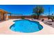 Backyard kidney-shaped pool with a tan concrete surround and a pergola in the background at 975 E Lincolnwood Cir, Casa Grande, AZ 85194