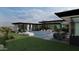 Modern backyard with a rectangular pool, patio furniture, a sculpture, and desert landscaping at 0 N 128Th St, Scottsdale, AZ 85255