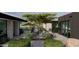 Landscaped courtyard with desert plants, rocks, and patio furniture, featuring an exercise space on the side at 0 N 128Th St, Scottsdale, AZ 85255