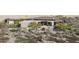 A modern home showcasing a grand entrance and a multi-car parking area, surrounded by native desert plants at 0 N 128Th St, Scottsdale, AZ 85255
