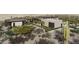 Landscaped view of desert home with drought tolerant foliage, 4-car garage and stone accents at 0 N 128Th St, Scottsdale, AZ 85255