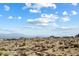 Distant view of houses surrounded by desert landscape, with mountains visible in the background at 0 N 128Th St, Scottsdale, AZ 85255