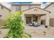 Backyard view showcasing the covered patio with modern outdoor furniture at 10050 E Texas Ave, Mesa, AZ 85212
