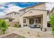 Spacious backyard with a covered patio, artificial turf, and desert landscaping at 10050 E Texas Ave, Mesa, AZ 85212