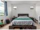 Bright bedroom with ceiling fan, neutral carpet, under-bed storage and large window at 10050 E Texas Ave, Mesa, AZ 85212