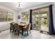 Dining room with seating for six, chandelier, sliding door to patio, neutral tones, and rug at 10050 E Texas Ave, Mesa, AZ 85212
