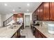 Open concept kitchen features granite countertops, stainless steel appliances and spacious island with a double sink at 10050 E Texas Ave, Mesa, AZ 85212