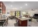 Open concept kitchen with island seating, view of living and dining areas, and modern appliances at 10050 E Texas Ave, Mesa, AZ 85212
