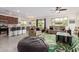 Spacious living room that opens to the kitchen with comfortable seating, ceiling fan, and open floor plan at 10050 E Texas Ave, Mesa, AZ 85212
