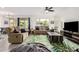 Comfortable living room with ample seating, ceiling fan, and view of the dining room at 10050 E Texas Ave, Mesa, AZ 85212
