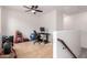 Open loft area featuring neutral carpet, ceiling fan, with workout equipment and computer desk at 10050 E Texas Ave, Mesa, AZ 85212