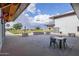 Relax in the outdoor seating area with multiple tables and chairs and an open field at 10050 E Texas Ave, Mesa, AZ 85212