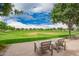 Seating area with comfortable chairs overlooking the community park with walking paths and manicured landscaping at 10050 E Texas Ave, Mesa, AZ 85212