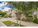 Street view of a two-story home with a desert landscaped yard, neutral color, and tile roofing at 10050 E Texas Ave, Mesa, AZ 85212