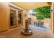 Back patio with brick pavers, a water feature, covered space and outdoor seating area at 1022 W Calypso Ct, Gilbert, AZ 85233