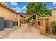 Inviting backyard patio with pergola, brick accents, outdoor fireplace, and space for entertaining at 1022 W Calypso Ct, Gilbert, AZ 85233