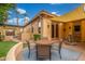 Charming backyard patio with comfortable seating, water feature, and lush landscaping at 1022 W Calypso Ct, Gilbert, AZ 85233