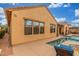 Rear exterior of tan house with pool and patio at 1022 W Calypso Ct, Gilbert, AZ 85233