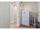 Hallway with appliances, doorway, and interior lighting at 1022 W Calypso Ct, Gilbert, AZ 85233