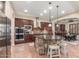 Gourmet kitchen boasts a stone island, stainless steel appliances, and custom cabinetry at 1022 W Calypso Ct, Gilbert, AZ 85233