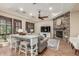 Inviting living room featuring a stone fireplace, ceiling fan, and ample seating at 1022 W Calypso Ct, Gilbert, AZ 85233