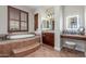 Luxurious main bathroom featuring a tub, step-up platform, and mosaic tile accents at 1022 W Calypso Ct, Gilbert, AZ 85233