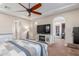 Comfortable primary bedroom suite with a decorative ceiling fan and fireplace at 1022 W Calypso Ct, Gilbert, AZ 85233