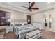 Spacious main bedroom with ceiling fan, bench seat, and ensuite bathroom access at 1022 W Calypso Ct, Gilbert, AZ 85233