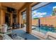 Enclosed patio with a view of pool, palms, and outdoor seating at 1022 W Calypso Ct, Gilbert, AZ 85233