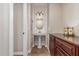 Charming powder room featuring a pedestal sink, decorative mirror and lots of light at 1022 W Calypso Ct, Gilbert, AZ 85233