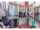 Fully-organized walk-in closet with multiple hanging racks, shelving, and storage bins at 1022 W Calypso Ct, Gilbert, AZ 85233