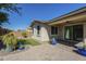 Serene backyard featuring artificial grass, a covered patio, and beautiful potted plants at 10609 E Durant Dr, Mesa, AZ 85212