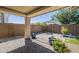 Charming covered patio and paver patio with beautiful landscaping and string lights for outdoor enjoyment at 10609 E Durant Dr, Mesa, AZ 85212