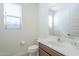 Powder room featuring a window, toilet, vanity, and mirror at 10609 E Durant Dr, Mesa, AZ 85212