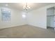 Neutral carpeted bedroom with chandelier style ceiling light at 10609 E Durant Dr, Mesa, AZ 85212