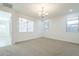 Spacious bedroom featuring ample natural light from large windows and neutral carpet at 10609 E Durant Dr, Mesa, AZ 85212