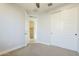 A bedroom features carpet, a closet with sliding doors, and an open door at 10609 E Durant Dr, Mesa, AZ 85212