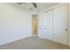 This carpeted bedroom has a closet, ceiling fan, and en suite bathroom at 10609 E Durant Dr, Mesa, AZ 85212