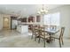 Open concept dining area with chandelier, large windows, and a view into the adjacent kitchen area at 10609 E Durant Dr, Mesa, AZ 85212