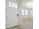 Bright entryway featuring a white front door, tile flooring, and views into the adjacent living space at 10609 E Durant Dr, Mesa, AZ 85212
